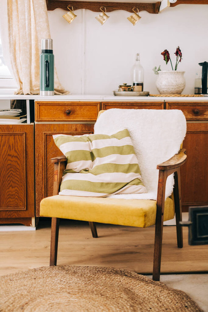 Armchair with pillow in the kitchen of countryside house, nobody. - Foto, afbeelding
