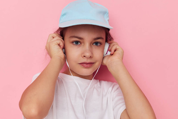 Portrait of happy smiling child girl listening to music on headphones Lifestyle unaltered - Foto, immagini