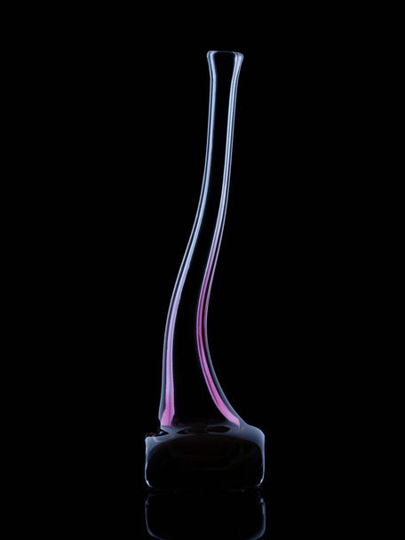 curved violet vase isolated with black background, black reflective background with rim light - Фото, зображення