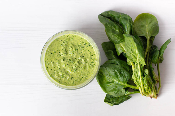 Delicious spinach sauce on a white table, flat lay. Place for text. - Photo, Image