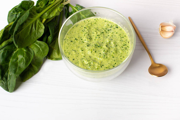 Delicious spinach sauce on a white table. - Φωτογραφία, εικόνα