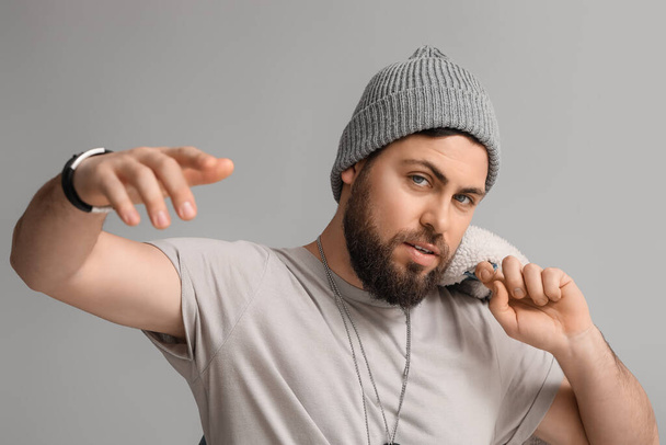Stylish cool bearded man on grey background - Photo, Image