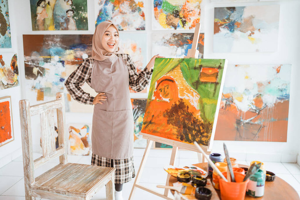 female painting artist showing and presenting her work - Photo, image