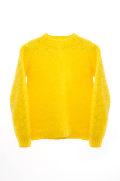 Orange or yellow knitted sweater on a white background top view. Trendy cozy knit. Jumper autumn accessories. Stylish sweatshirt on mannequin. Fashion Lady clothes - Fotó, kép