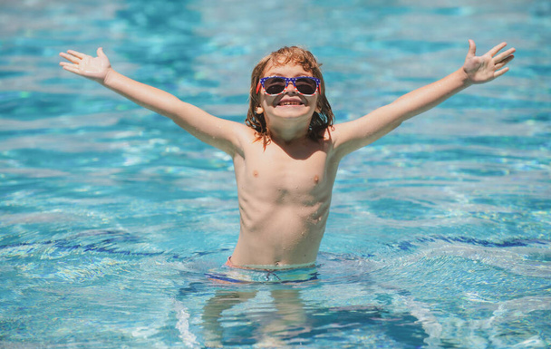 Child relax in summer swimming pool. Summertime and swimming activities for children on the pool. - Фото, изображение