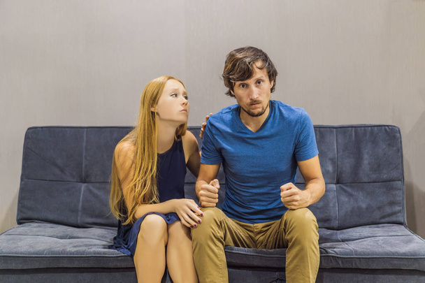 Young couple swears on the couch. Watch and evaluate their behavior from the side. Emotional intelligence concept - Photo, image