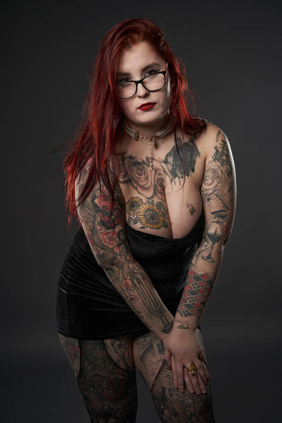 Beautiful size plus woman with tattoos in black mini dress, inclusiveness and body acceptance - Fotoğraf, Görsel