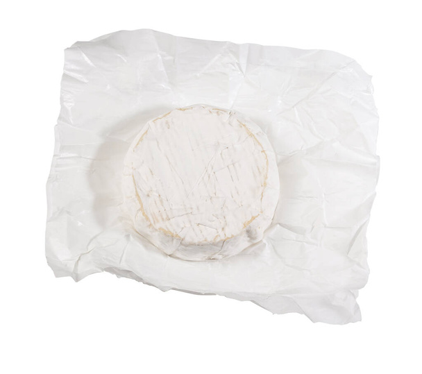camembert cheese on white wrapping paper on white background - Foto, Imagem