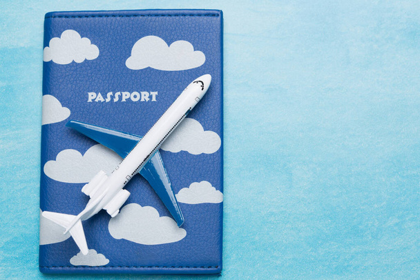 travel concept, toy airplane on passport, on blue background, air travel - Foto, Bild