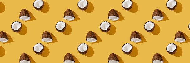 A pattern of coconuts on a bright yellow background. - Foto, immagini