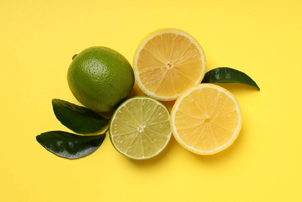 Concept of tasty food with citrus fruits on yellow background - Фото, зображення