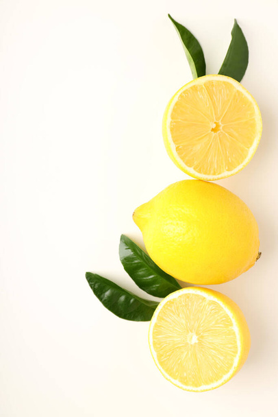 Lemons with leaves on white background, top view - Foto, Imagen