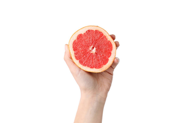 Női kéz tartja a fél grapefruit, elszigetelt fehér alapon - Fotó, kép