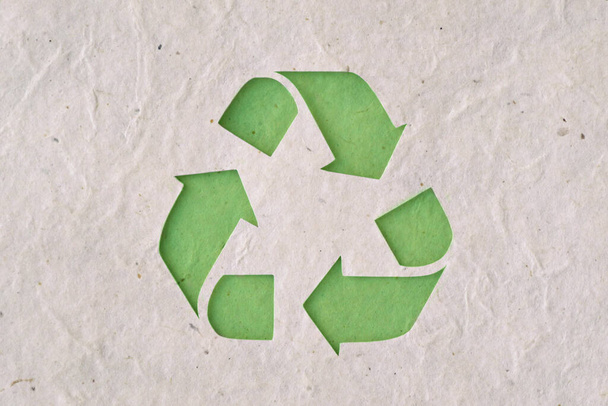 Recyclig symbol on recycled paper - Ecology concept - Foto, afbeelding