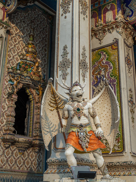 Bangkok, Thailand. Feb - 10, 2022 : Elaborate sculptures of monster is made of bricks and mortar, decorated with various colored glazed tiles at the chapel of The Pariwas Ratchasongkram temple. Selective Focus. - 写真・画像