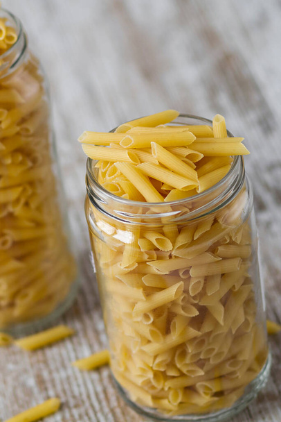 Transparent glass jars with raw pasta - Foto, Imagen