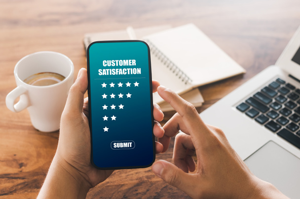 male customer gives a five-star rating on their smartphone, satisfaction, customer service experience. Service Rating Reviews and Satisfaction Survey Concept. - Photo, Image