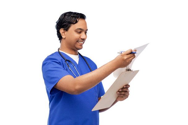 male doctor writing medical report on clipboard - Photo, image