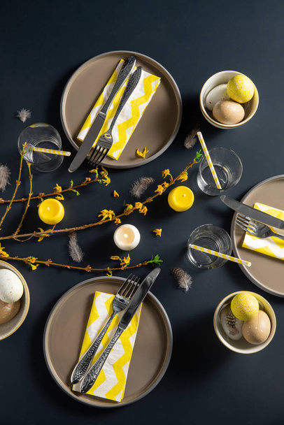 close up of easter table serving over black - Foto, afbeelding