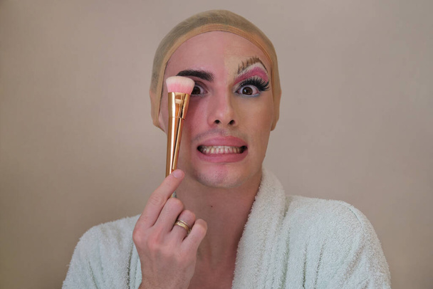 Half man half woman make up person. Drag queen person with a make-up brush. - Fotó, kép
