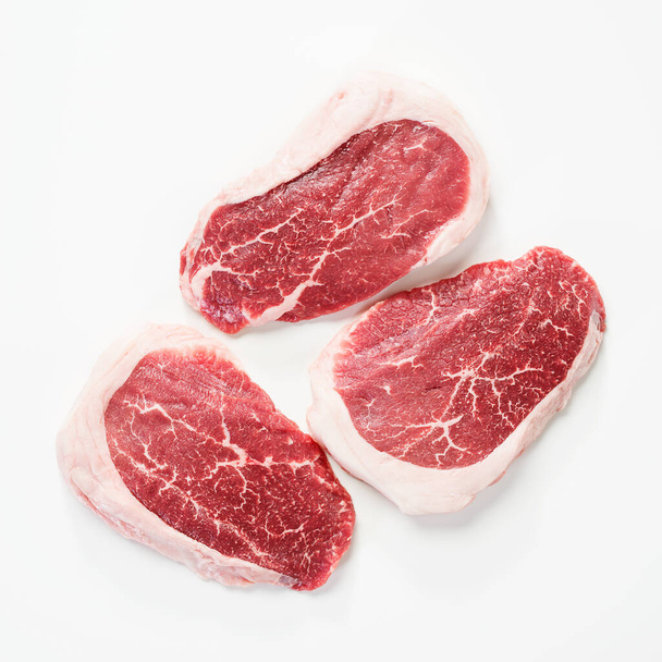 Raw Steak Ribeye Black Angus on white background. Top view. - Photo, Image
