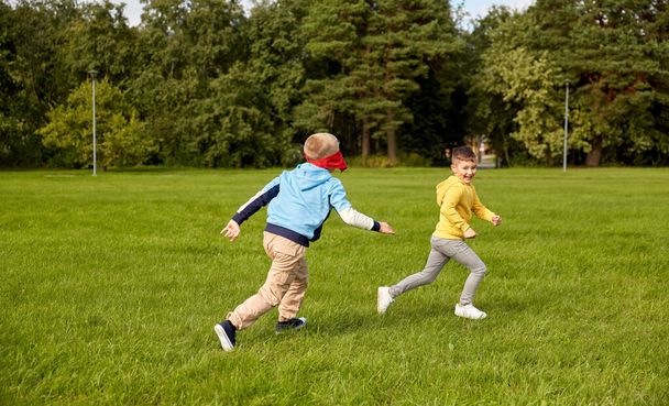happy boys playing and running at park - Фото, зображення