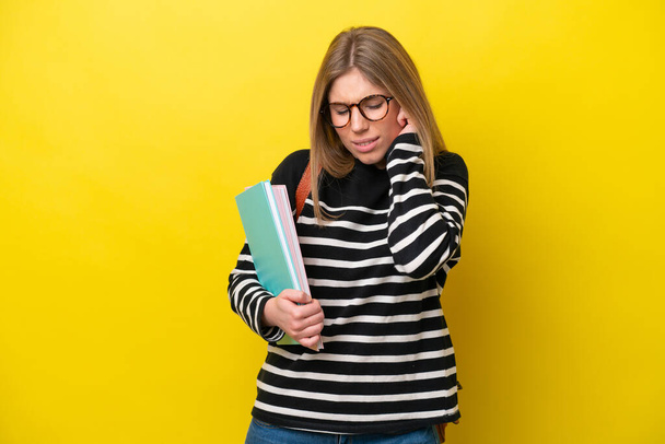 Young student woman isolated on yellow background background frustrated and covering ears - Photo, Image