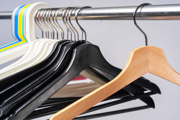 Metal rack with clothes hangers on grey background - Foto, Imagen