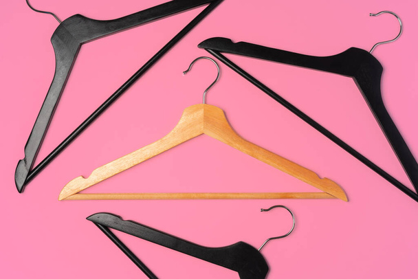 Flat lay composition with empty hangers on pink background - Foto, Bild