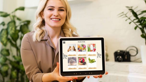 Woman using tablet to order food delivery at home - Photo, Image