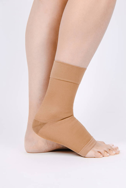 Orthopedic Ankle Brace. Medical Ankle Bandage. Medical Ankle Support Strap Adjustable Wrap Bandage Brace foot Pain Relief Sport. Leg Brace isolated on white background. Trauma Ankle orthosis. Injury - Valokuva, kuva