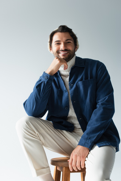 cheerful man in white trousers and blue jacket looking at camera isolated on grey - Fotoğraf, Görsel