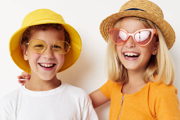 funny boy and girl wearing hats posing fashion light background - Fotoğraf, Görsel