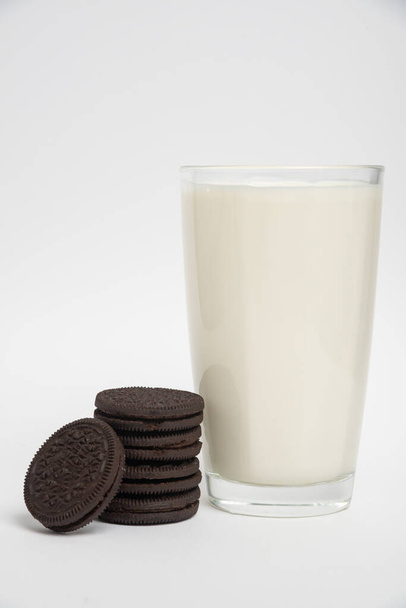Chocolate cookies with milk in a glass on a white background - Photo, Image