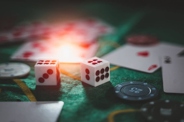 Casino concept close up dice, casino chips, cards on green felt. - Foto, Imagen