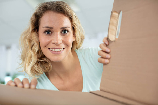 happy woman opening postal package - Fotoğraf, Görsel