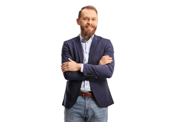 Young bearded man in a suit and jeans posing with crossed arms isolated on white background - Φωτογραφία, εικόνα