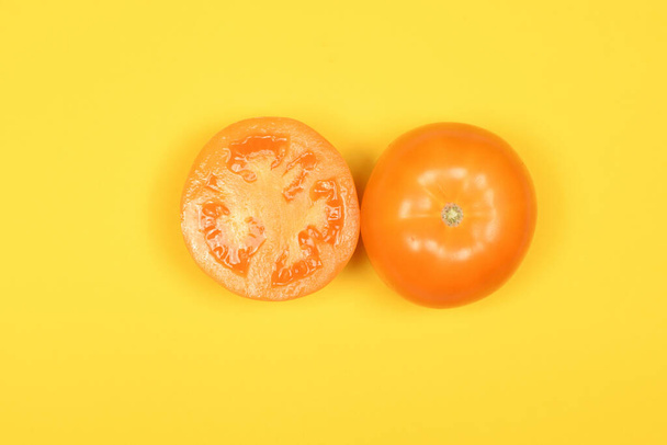 Yellow tomato isolated on yellow. High resolution photo. Full depth of field. - Photo, Image