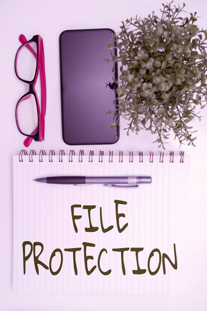Writing displaying text File Protection. Word for Preventing accidental erasing of data using storage medium Office Supplies Over Desk With Keyboard And Glasses And Coffee Cup For Working - Photo, Image