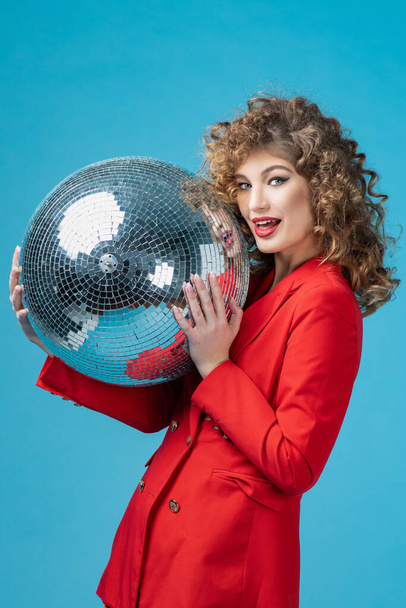 Party woman with disco ball - 写真・画像