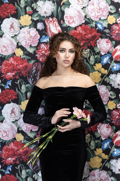 Beautiful romantic young woman posing on a background of roses. Inspiration of spring and summer. Perfume, cosmetics concept. - Zdjęcie, obraz