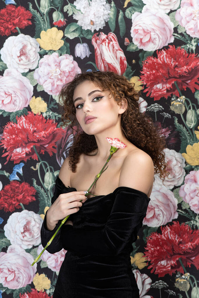 Portrait of young charming woman with flowers background - Zdjęcie, obraz