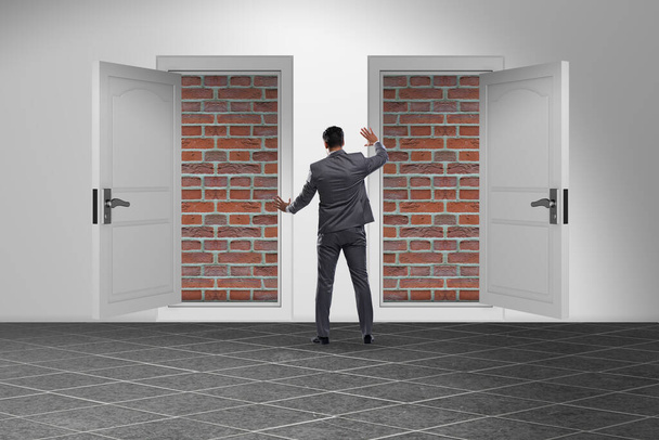 Businessman facing no exit with brick door - Photo, Image