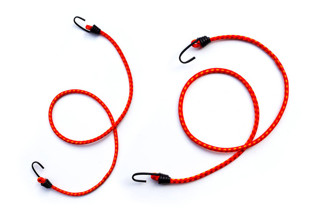 Braided elastic strap with hooks on white background. - Photo, Image