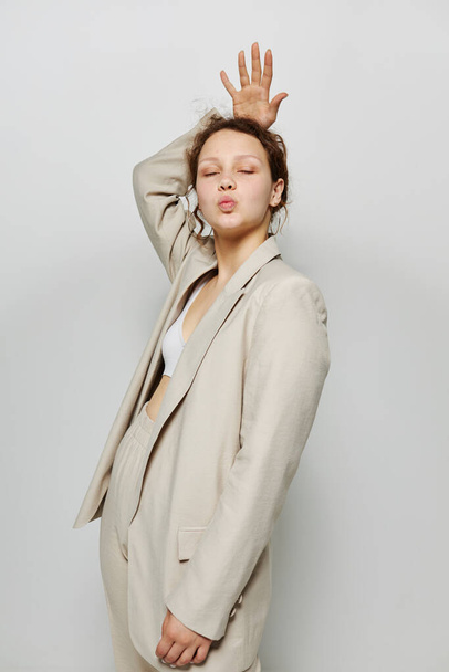 portrait of a young woman Clothes fitting elegant style suit fashion studio light background unaltered - Fotó, kép