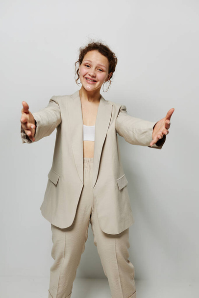 cheerful woman classic suit fashion posing fun light background unaltered - Foto, imagen