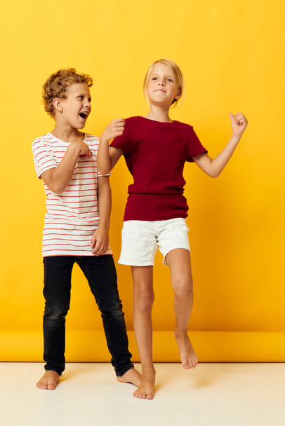 two joyful children standing side by side posing childhood emotions isolated background - Fotoğraf, Görsel