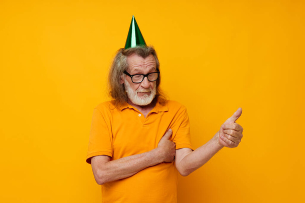Portrait of happy senior man wearing glasses green cap on his head holiday emotions unaltered - Fotografie, Obrázek
