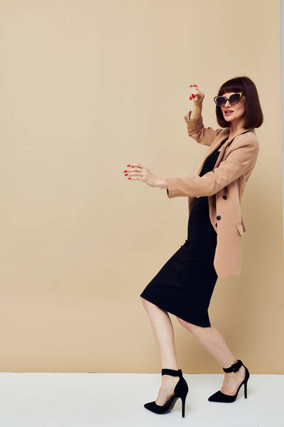 attractive woman Charm red nails model luxury sunglasses light background - Fotó, kép