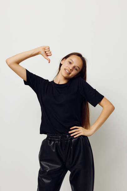 beautiful girl in a black t-shirt hand gesture fun fitness training - Photo, Image
